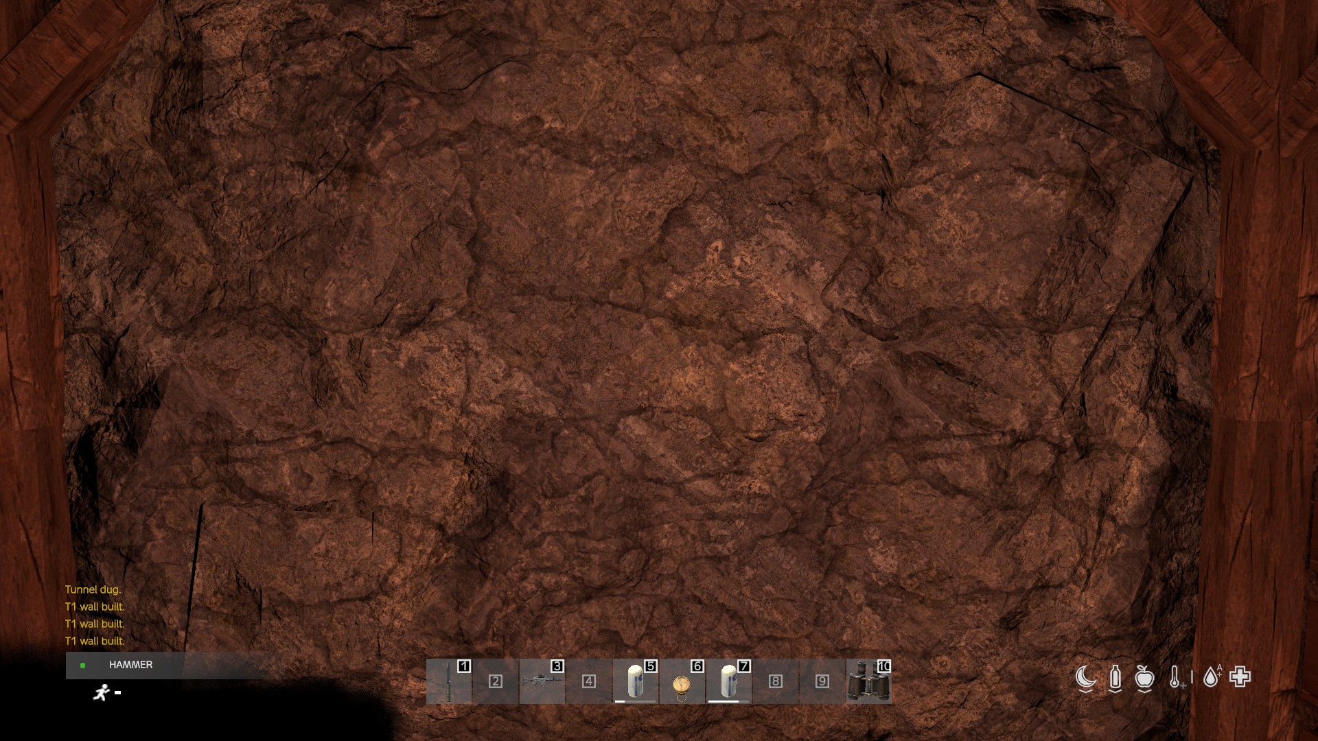 A bedrock face at the back of a deep cube — solid rock you can't dig through.